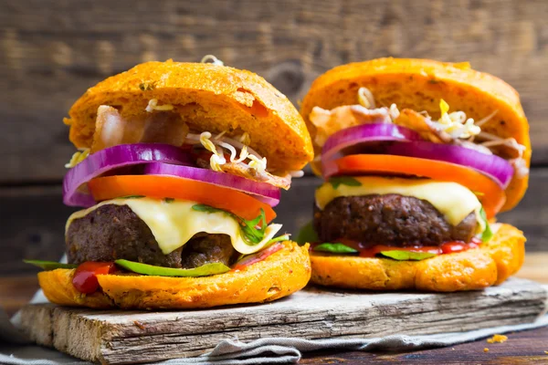 Big homemade burgers on table — Stock Photo, Image