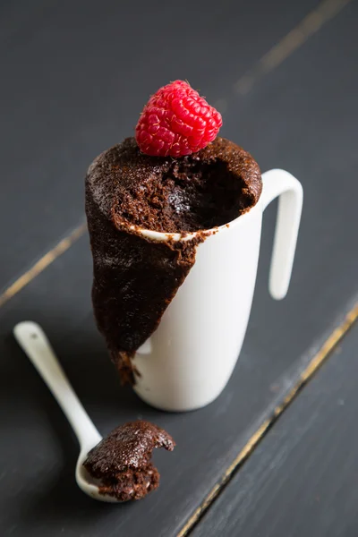 Chocolate brownie with fresh raspberries in a mug