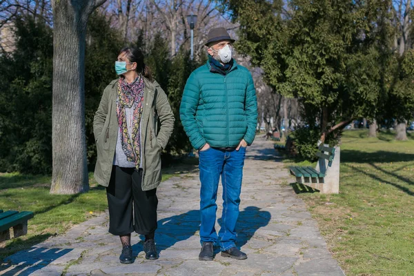 two people walking in the park during coronavirus epidemic quarantine
