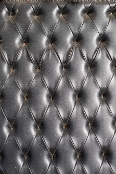 old leather sofa cushion with rivets texture