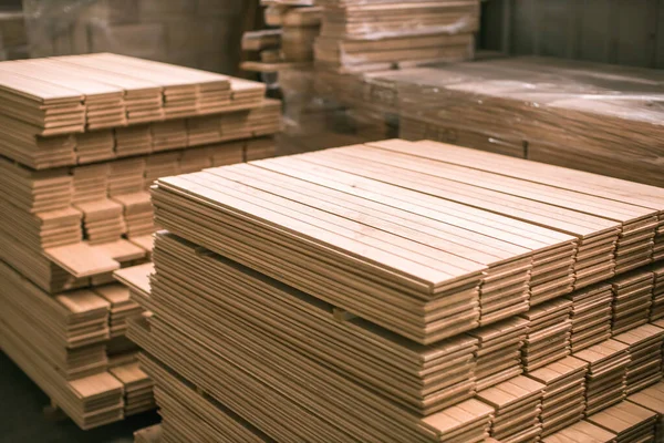 hardwood flooring planks being stored in wood production factory