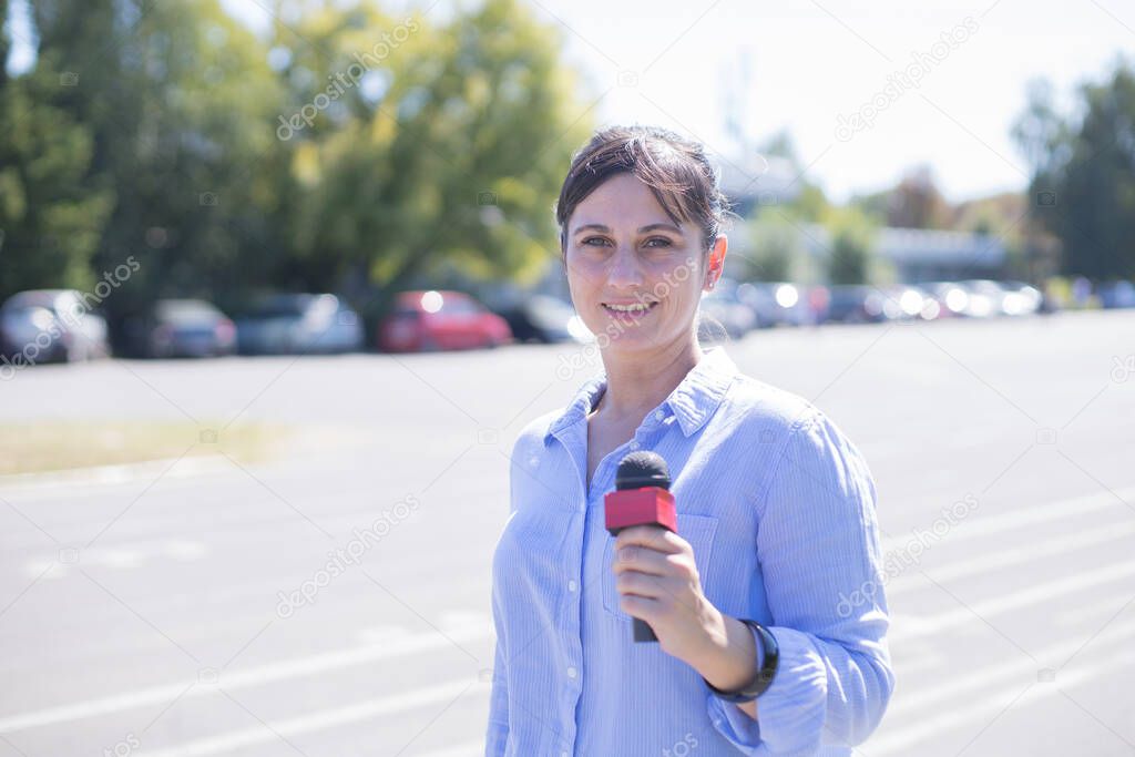portrait of a woman reporter reporting outdoors
