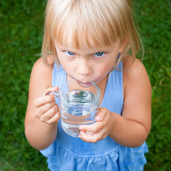 Child drinking water outdoors Royalty Free Stock Images