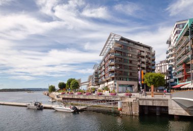 OSLO, NORway - 23 Temmuz 2018: Oslo 'daki Fjord City kentsel yenileme projesinin bir parçası olan yenilenmiş Tjuvholmen liman bölgesinde modern İskandinav mimarisi