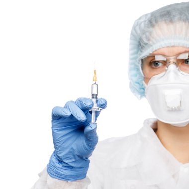 Close-up shot of doctor wearing PPE protective suit, goggles and FFP3 face mask holding syringe ready for injection of a vaccine or medicine