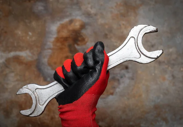 Person Wearing Protective Glove Holding Big Wrench Rusty Metal Background — Stock Photo, Image