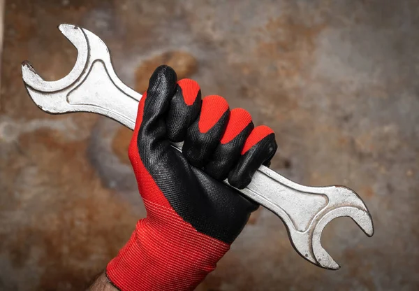 Person Wearing Protective Glove Holding Big Wrench Rusty Metal Background — Stock Photo, Image