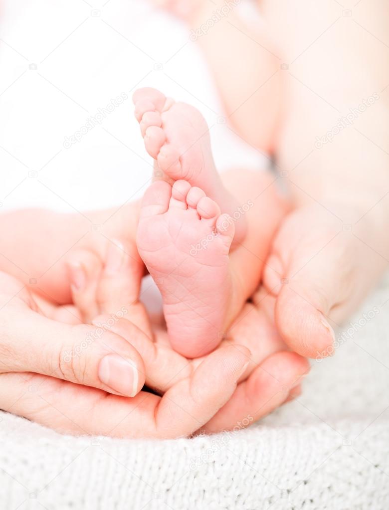 Mother holding baby's feet