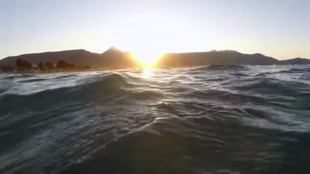 Vågor på en strand i solnedgången — Stockvideo