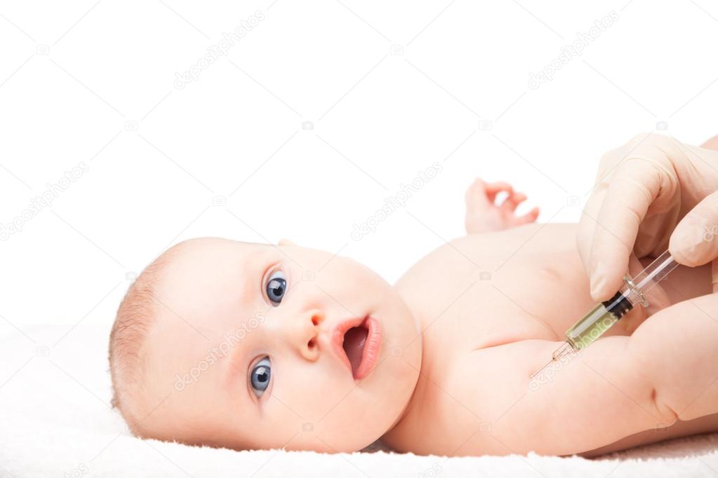 Pediatrician giving baby girl intramuscular injection