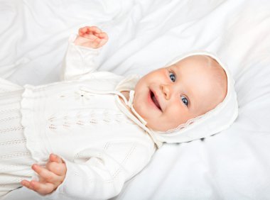 Infant in baptismal clothes