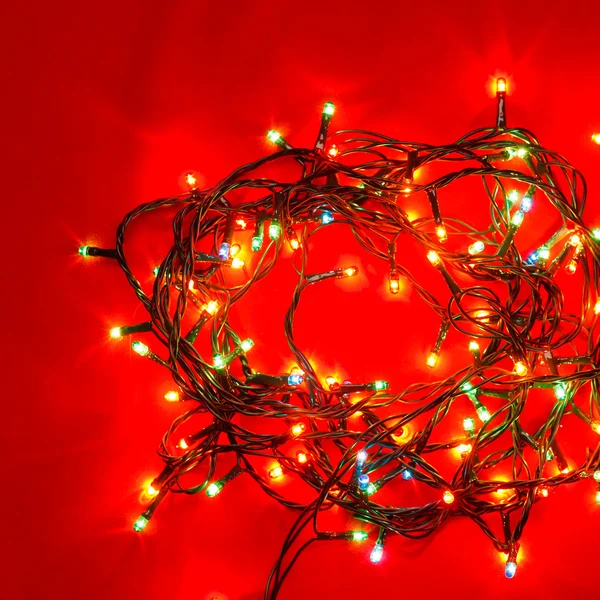 Christmas lights on red — Stock Photo, Image