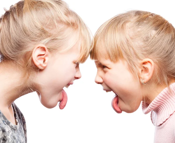 Children sticking out tongues arguing — Stock Photo, Image