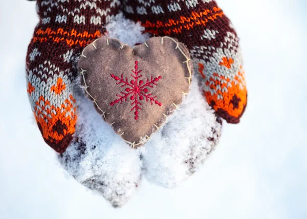 Mittens with heart on snow winter holidays concept — Stock Photo, Image