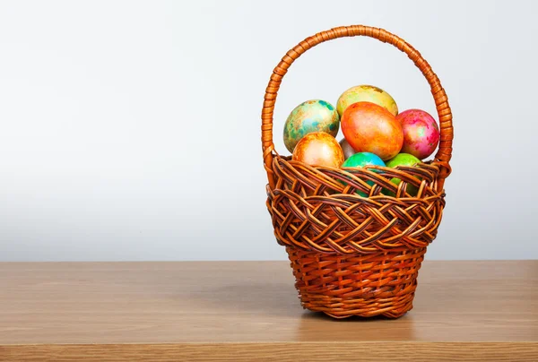 Painted easter eggs in a basket — Stock Photo, Image