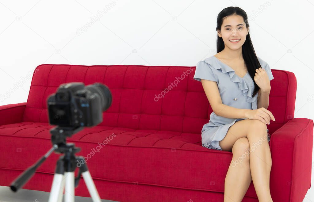Asian famale model sitting on sofa and pose to camera