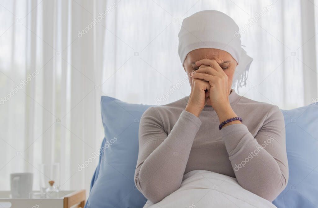 A middle-aged breast cancer woman feels hopeless and fear for her sickness and praying for calmness and mind serenity.