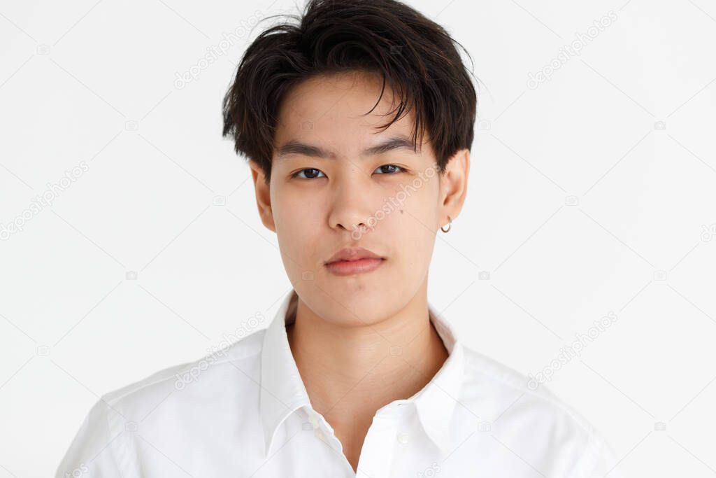 Portrait of a handsome tomboy, a girl who loves to be a man, on white background.