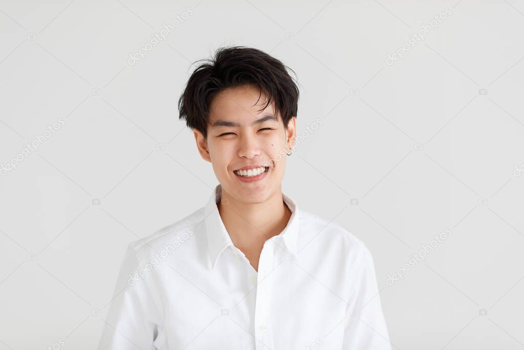 Portrait of a handsome good looking tomboy, a girl who loves to be a man, on white background.