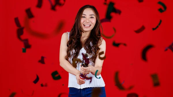 Funny Young Cure Asian Girl Holding Blowing Out Party Poppers — Stock Photo, Image