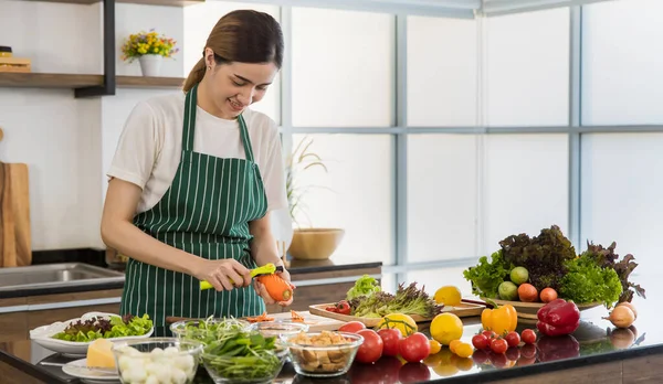 Happy Asian Woman Striped Apron Smiling Peeling Carrot While Cooking — Stock Photo, Image