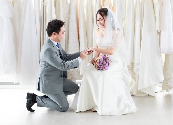 Groom Gray Suit Kneels Wears Wedding Ring Bride White Lace — Stock Photo, Image