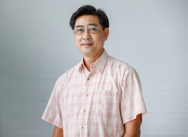 Portrait of warm personality senior older man wearing eyeglasses with smile face poses to a camera with self-confidence and good looking.