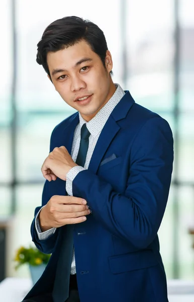Cheerful Young Handsome Asian Businessman Adjusting Sleeve While Standing Happy — Stock Photo, Image