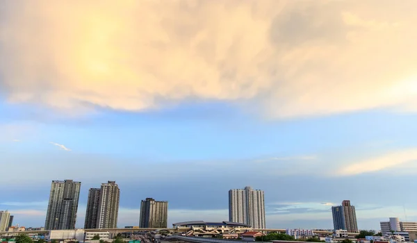 Background of outdoor blue sky, sunset light and clouds in evening with landscape of urban city modern buildings, cityscape and blank copy space