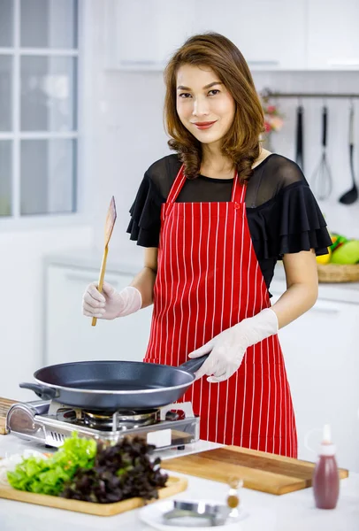 Beautiful Brunette Asian Housewife Red Apron Putting Pan Hot Stove — Stock Photo, Image