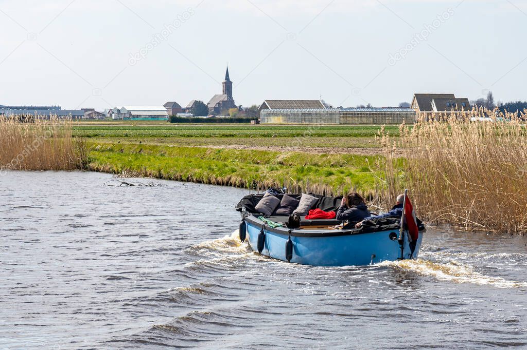 From a boat you have a beautiful view of the many fields with blooming flower bulbs near Lisse, the Netherlands