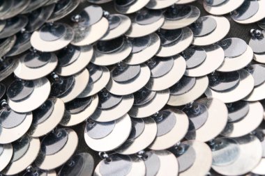 Beyaz arkaplanda siyah pullu elbisenin yakın çekimi