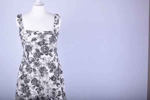 Women\'s dress on mannequin against studio background