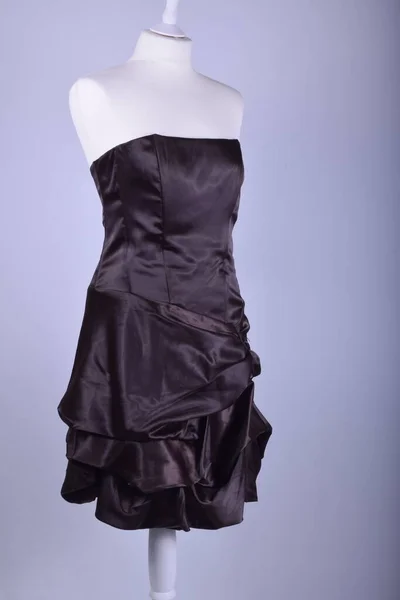 Women's dress on mannequin against studio background