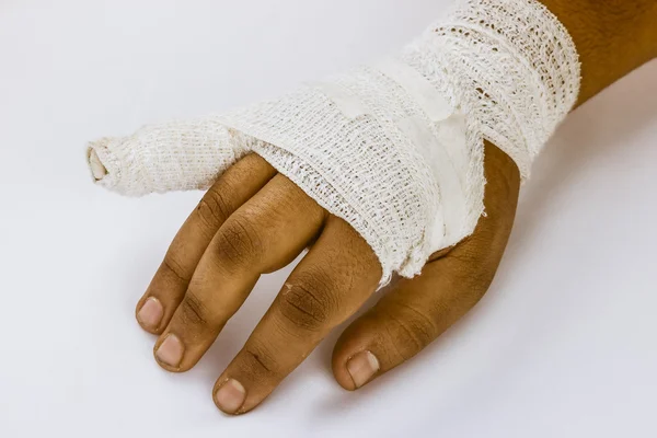 Splint finger a broken bone with a bandage Royaltyfria Stockbilder