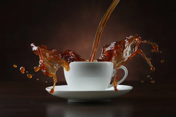 Pouring Coffee Porcelain Cup Splash Brown Background — Stock Photo, Image