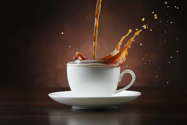 Pouring Coffee Porcelain Cup Splash Brown Background — Stock Photo, Image