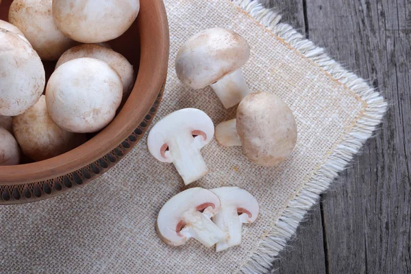 Champignons in a ceramic plate on old wood table — Stock Photo, Image