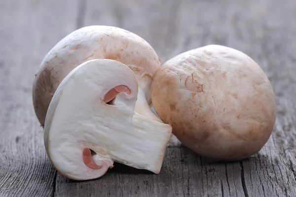 Champignons on old wood table — Stock Photo, Image