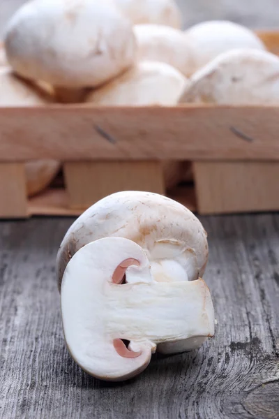 Champignons in a wooden box on old table — Stock Photo, Image