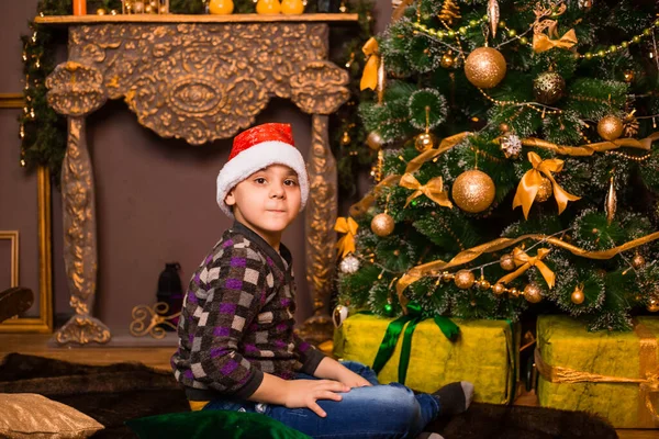 Boy Wearing Santa Hat Decorating Christmas Tree — Stock Photo, Image