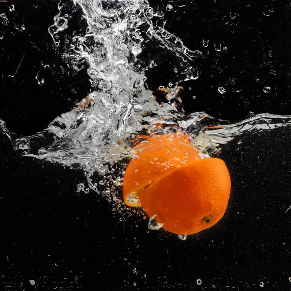 Fresh Two Parts Orange Slices Falling Water Splash Water Air Stock Picture