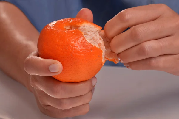 woman  peeling tangerine fruit.