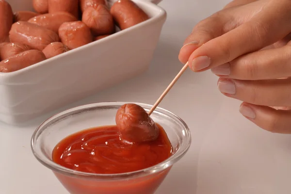 Woman Picking mini sausage — Stock Photo, Image