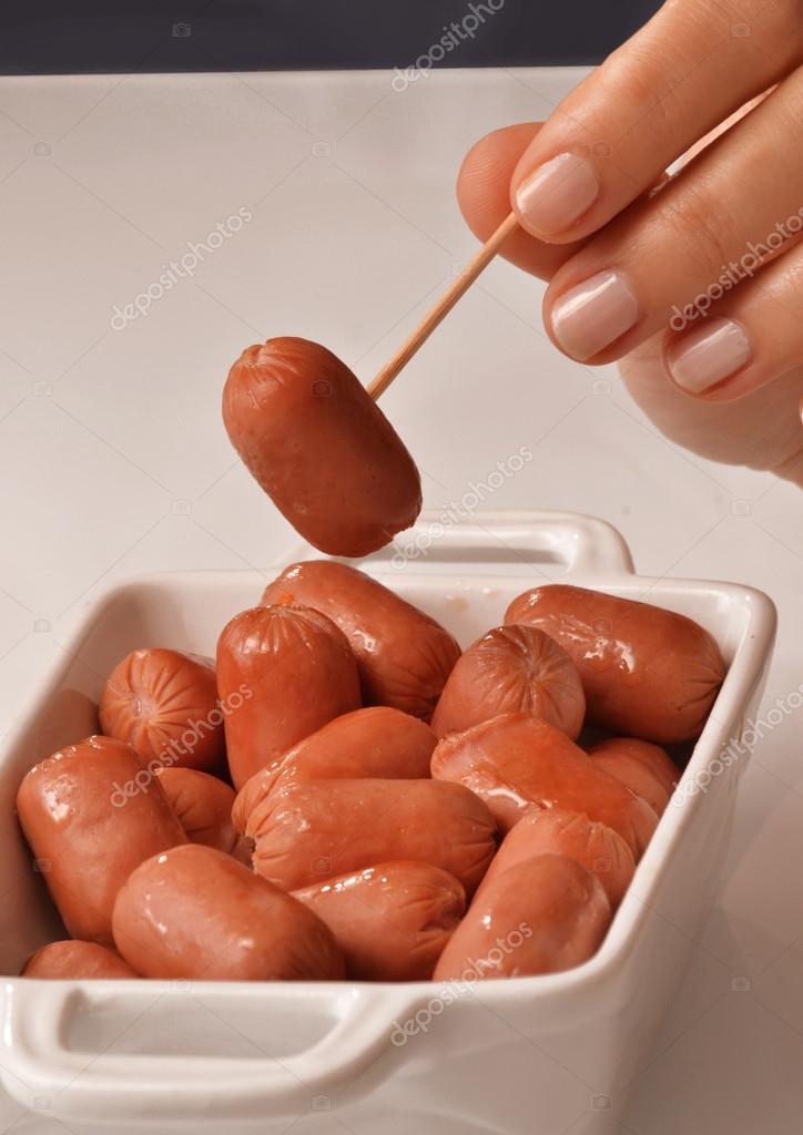 Woman Picking Mini Sausage Stock Photo C Gosphotodesign