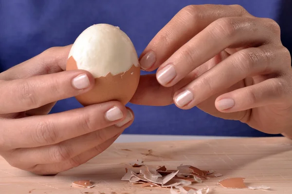 woman shelling an egg