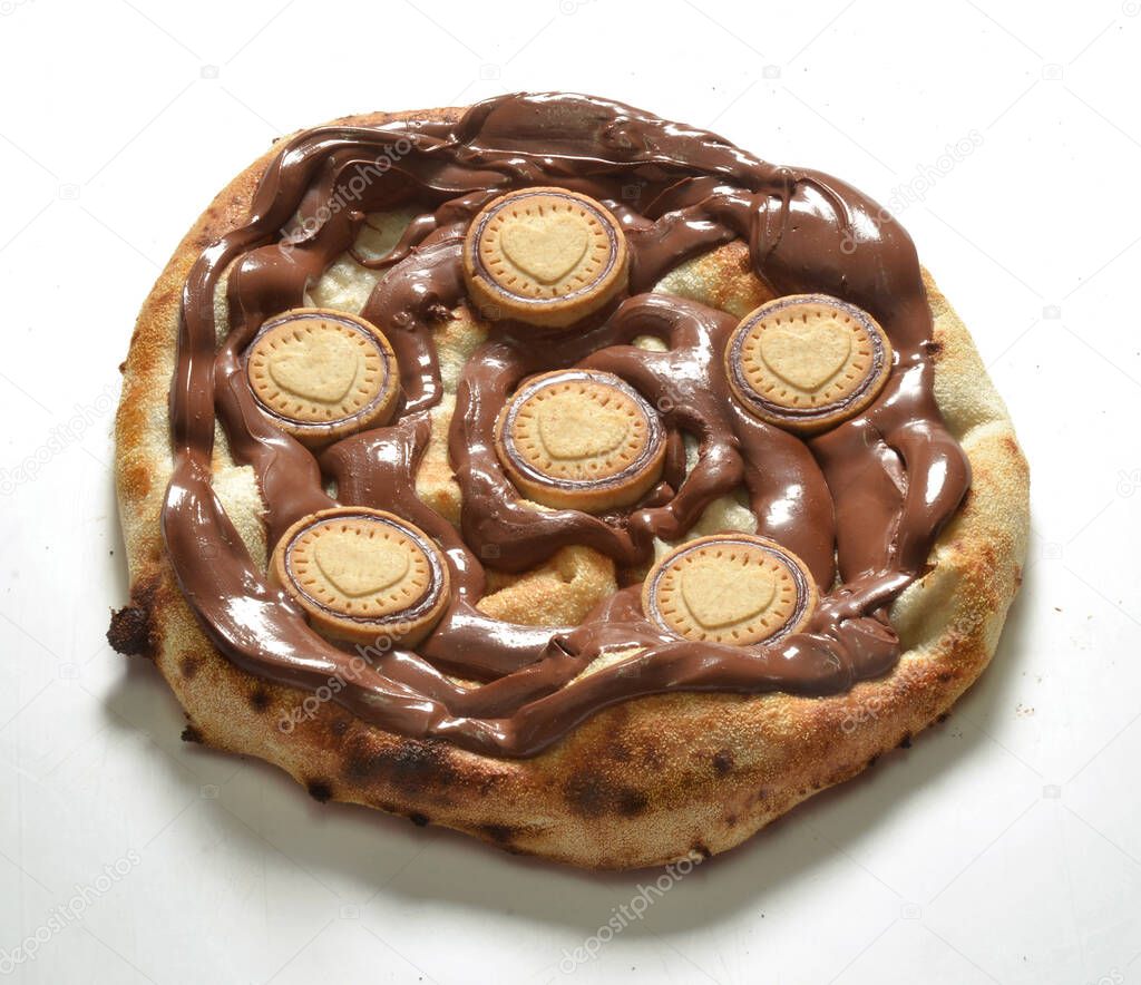Fused chocolate and cookies pizza isolated on white background.