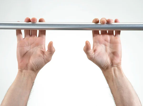 Hands hanging a metallic bar — Stock Photo, Image