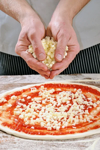 Cook hands preparing pizza — Stock Photo, Image