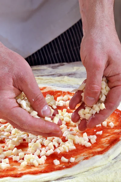 Adding ingredients on pizza. — Stock Photo, Image